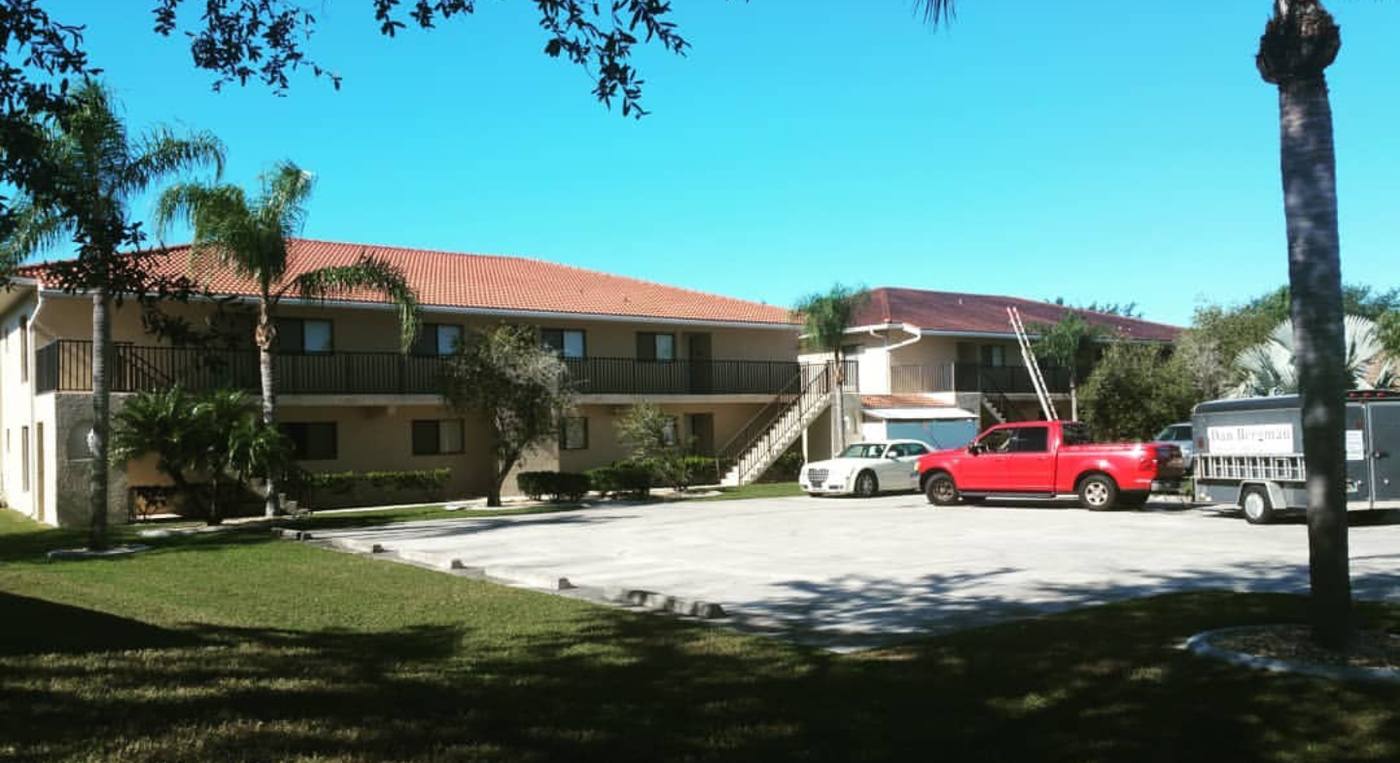 Apartment complex with cleaned roofs and walkways and the work truck and trailer on site