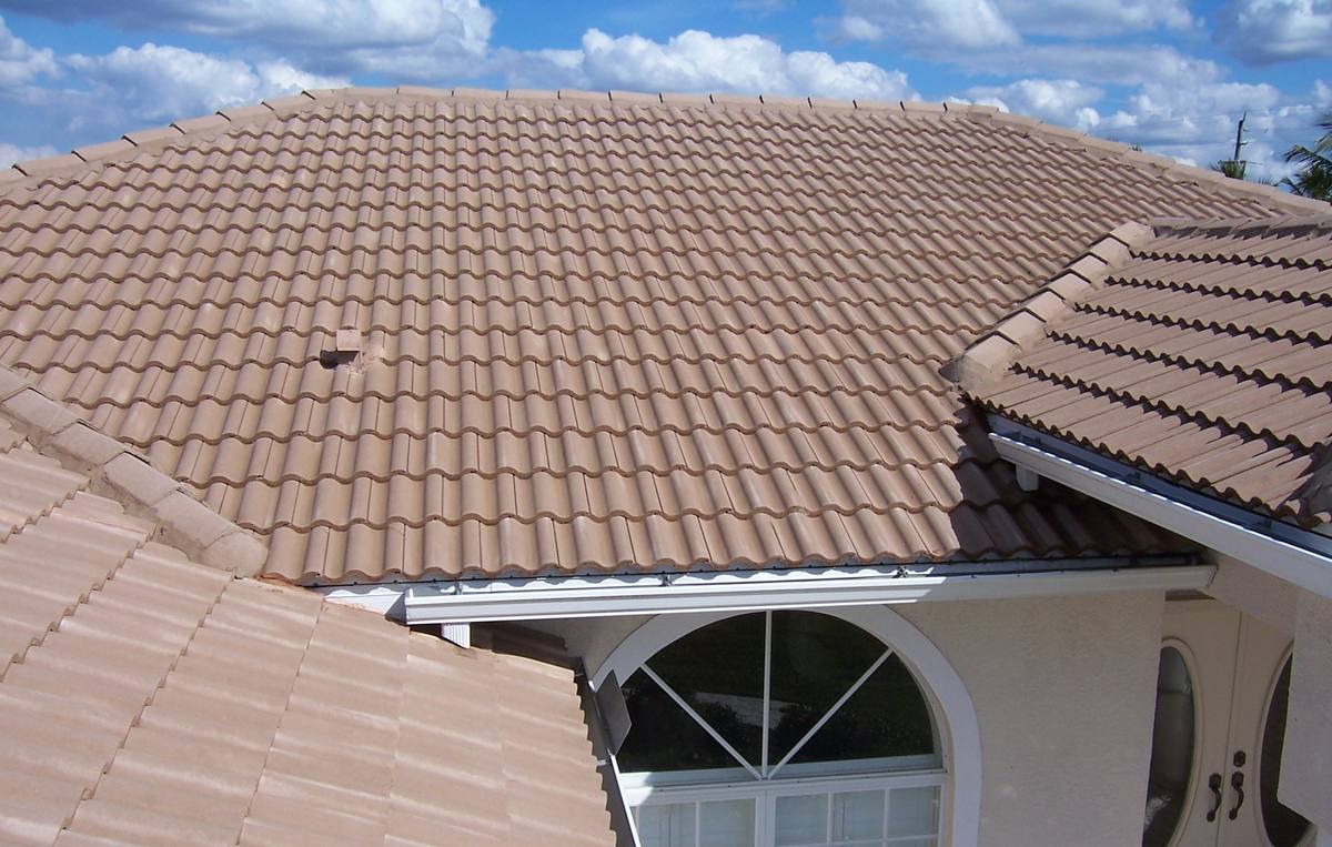 The same barrel-tile roof back to clean tan tile after a soft wash